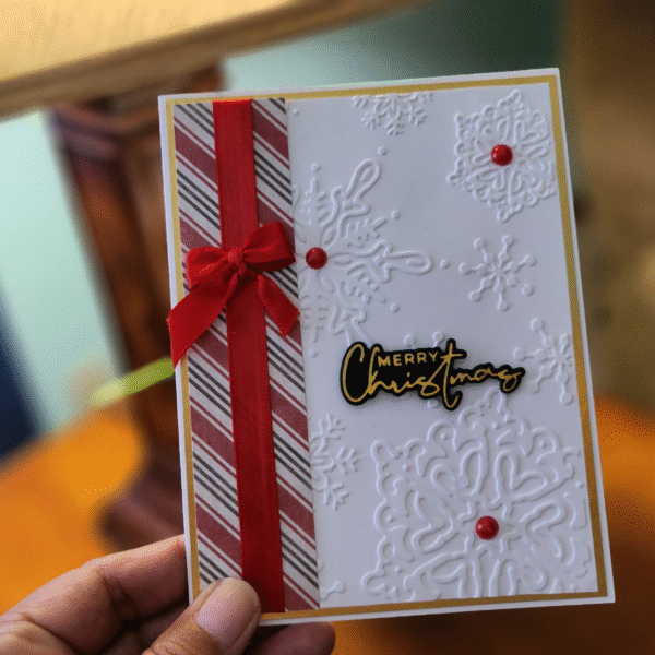 Elegant Embossed Snowflake Christmas Card with Red Bow Description: