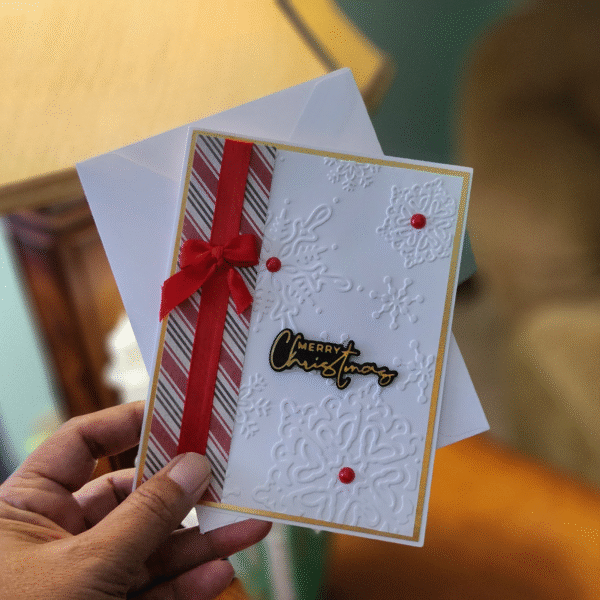 Elegant Embossed Snowflake Christmas Card with Red Bow Description: